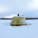 The three-country cairn painted yellow marks the international borders between the three nordic countries, Sweden, Norway and Finland.