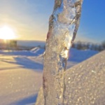 The eye is drawn to the roof where the sun shines and makes the the oddly shaped ice sparkle.