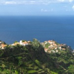 Sur la côte Sud, les petites maisons blanches de Madère se mêlent harmonieusement au vert des collines et au bleu de l’océan Atlantique