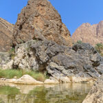 The ochre rocks of Wadi Al Arbiyeen are reflected in many natural pools along the Wadi.