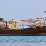 The dhows parked in the port of Sour are recognizable by their slender silhouette and their wooden hull.