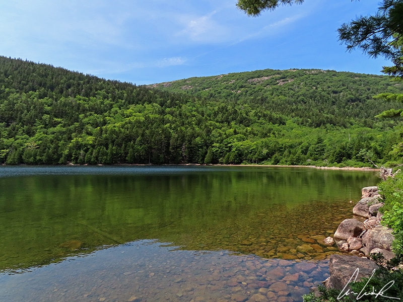 The dense forests that grow along the shores of Jordan Pond invite the visitor to take a stroll. Although this crystal water may be inviting, wading or swimming is not allowed.