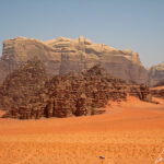 The Wadi Rum is 278 mi2 area, in the desert landscape, where a maze of sheer-sided sandstone and granite monoliths rise up from the valley floor.