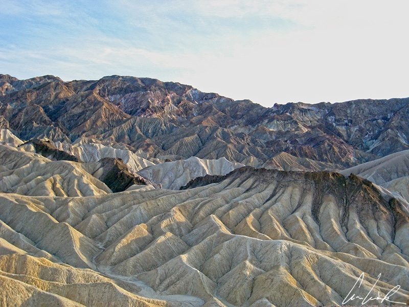 The spectacular view from Zabriskie Point is some of the most photographed in Death Valley National Park. It is a colorful landscape of gullies and mud hills.
