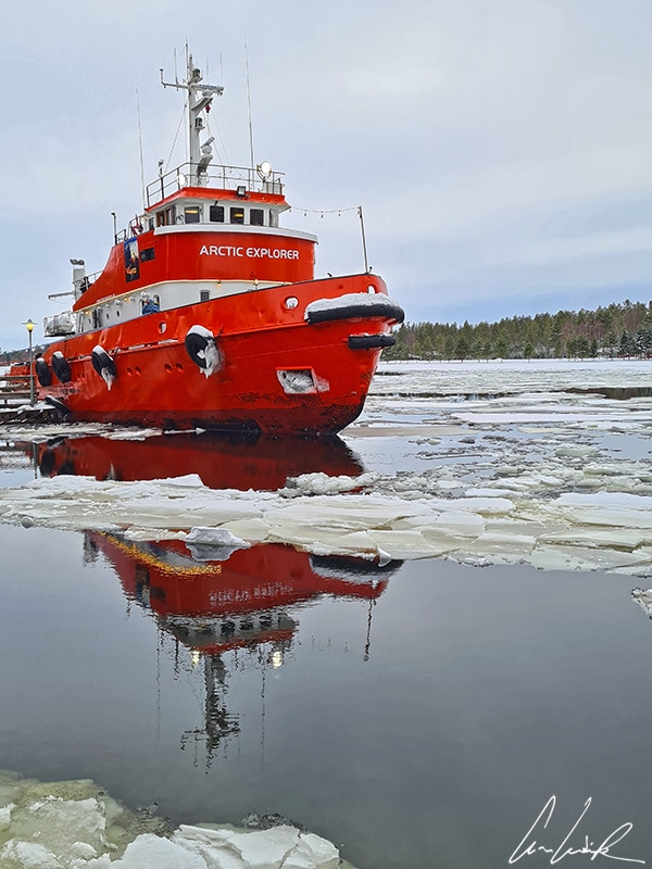 The Arctic Explorer icebreaker docks, awaiting passengers for a frosty cruise. This red-and-white icebreaker was built in 1962.